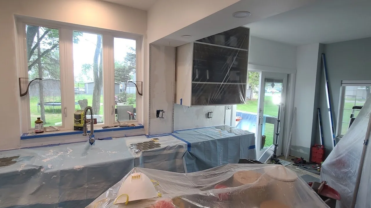 Plastic sheeting taped over countertops and windows before demolition begins